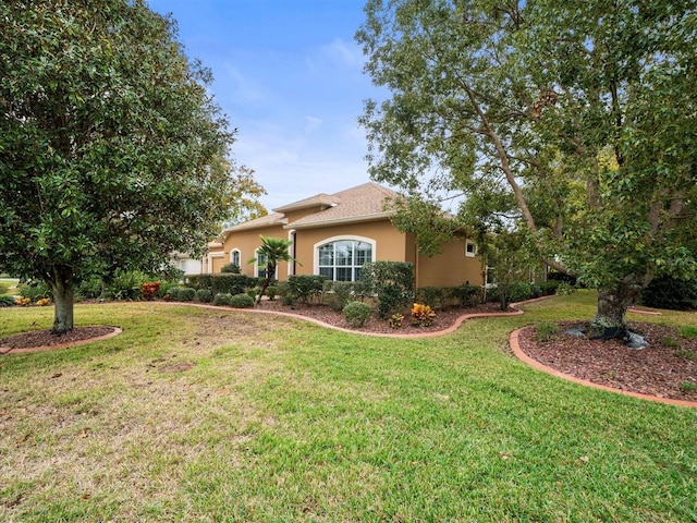 view of side of property with a lawn