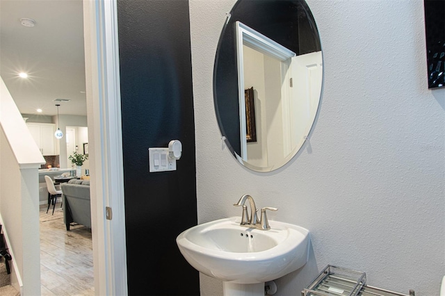 bathroom featuring wood-type flooring and sink