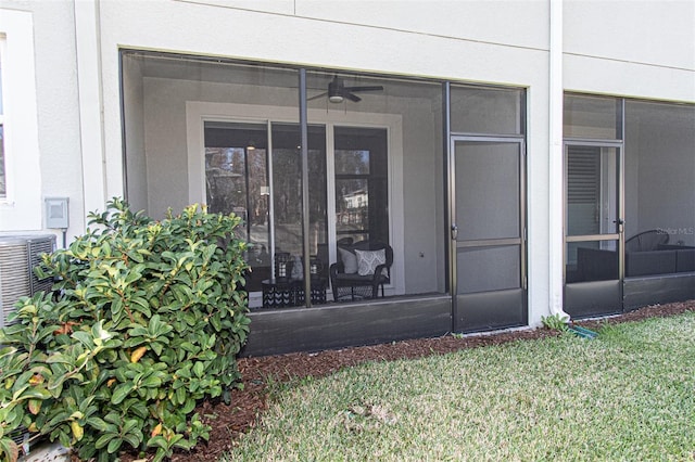 entrance to property featuring a lawn