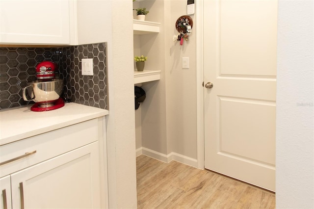 bathroom featuring tasteful backsplash and hardwood / wood-style flooring