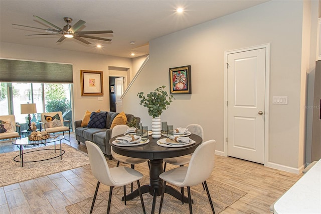 dining area with light hardwood / wood-style flooring and ceiling fan