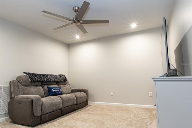 carpeted living room with ceiling fan