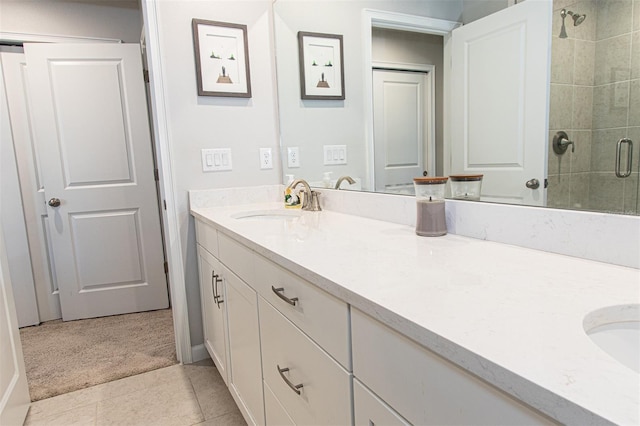 bathroom featuring tile patterned flooring, vanity, and walk in shower