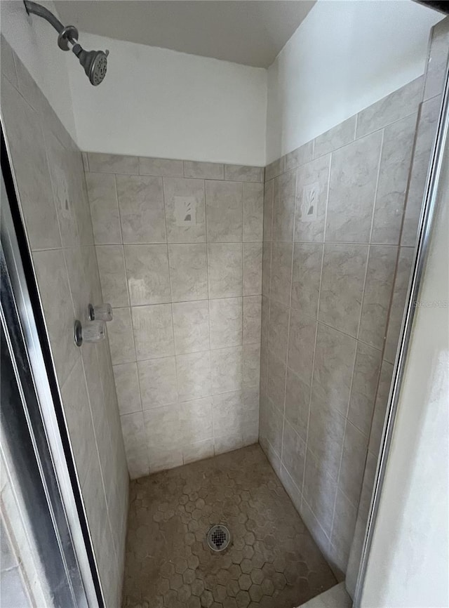 bathroom with tiled shower