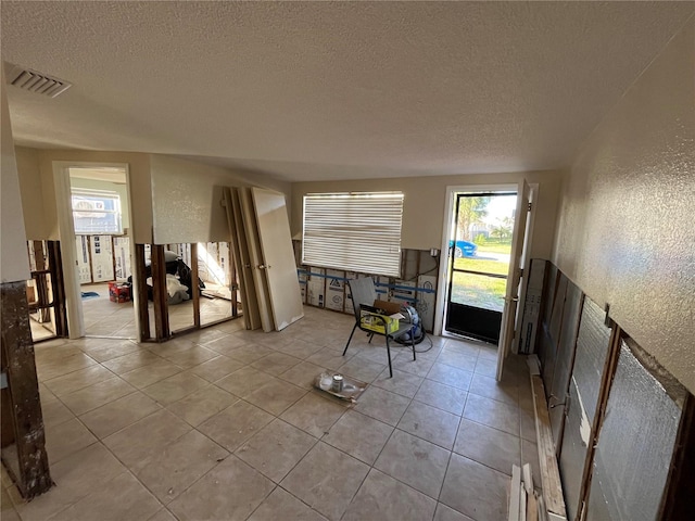 living room with light tile patterned floors and a textured ceiling