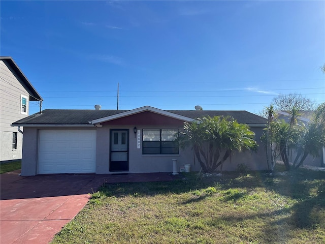 ranch-style home featuring an attached garage, a shingled roof, driveway, stucco siding, and a front yard