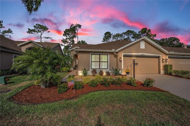 view of front of property featuring a garage and a yard