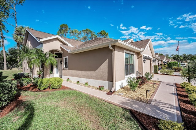 view of side of property with a garage and a yard