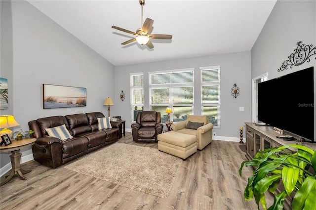 living room with vaulted ceiling, light hardwood / wood-style floors, and ceiling fan