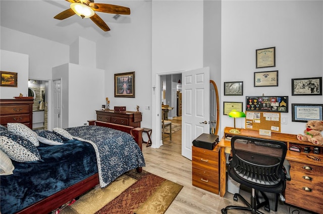 bedroom with ceiling fan, high vaulted ceiling, and light hardwood / wood-style flooring