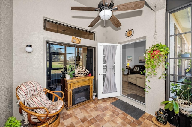 interior space with ceiling fan