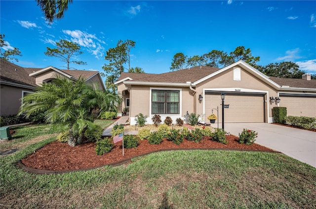 single story home featuring a garage and a front lawn