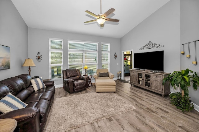 living room featuring ceiling fan, high vaulted ceiling, and light hardwood / wood-style floors