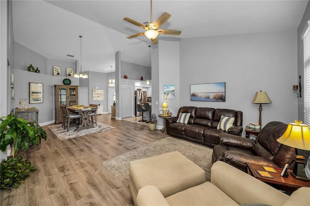 living room featuring high vaulted ceiling, hardwood / wood-style floors, and ceiling fan