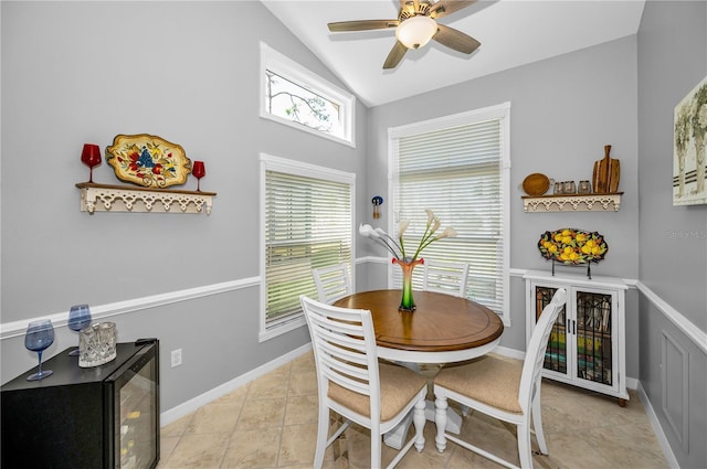 dining area featuring lofted ceiling, light tile patterned floors, and ceiling fan