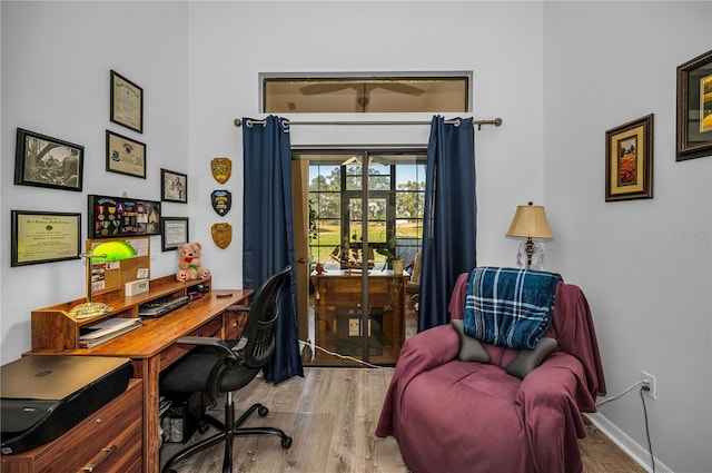 home office with wood-type flooring