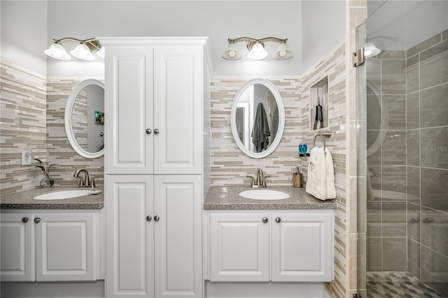 bathroom featuring vanity, backsplash, tile walls, and walk in shower