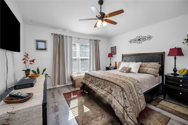 bedroom featuring ceiling fan and dark hardwood / wood-style floors