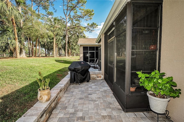 view of patio / terrace featuring a sunroom and area for grilling