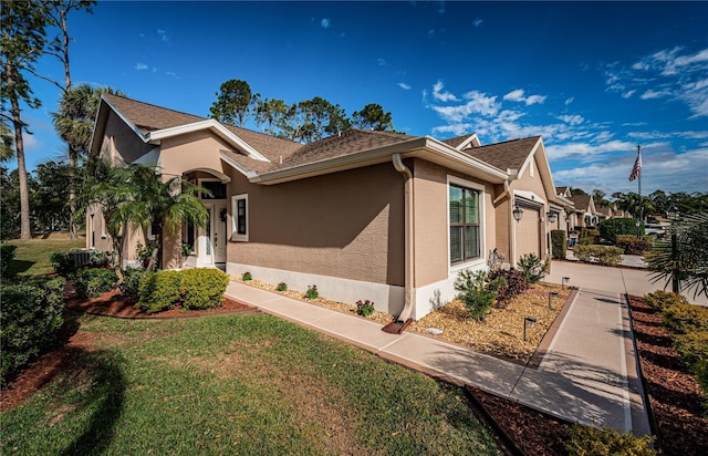 view of home's exterior featuring a garage and a lawn