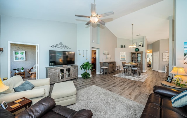 living room with ceiling fan, hardwood / wood-style floors, and high vaulted ceiling