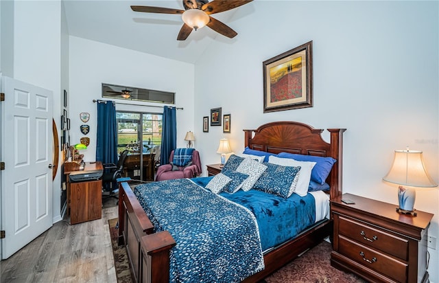 bedroom featuring wood-type flooring, ceiling fan, and high vaulted ceiling