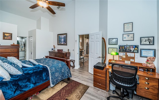 bedroom featuring high vaulted ceiling and light hardwood / wood-style floors