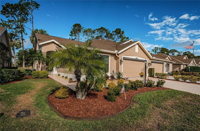 view of front of property with a garage and a front lawn