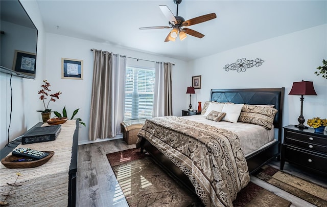 bedroom with dark wood-type flooring and ceiling fan