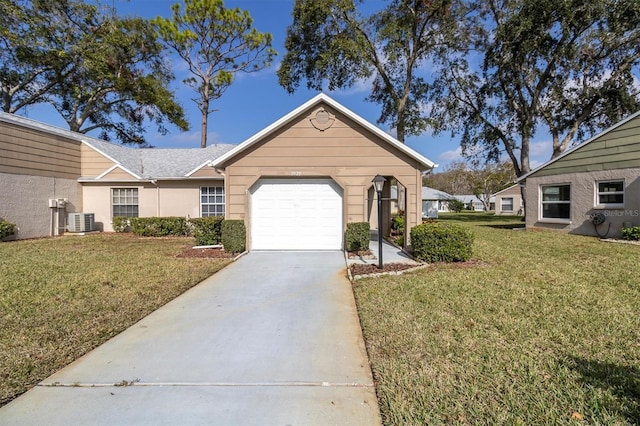 view of front of house featuring central air condition unit, a front lawn, and a garage