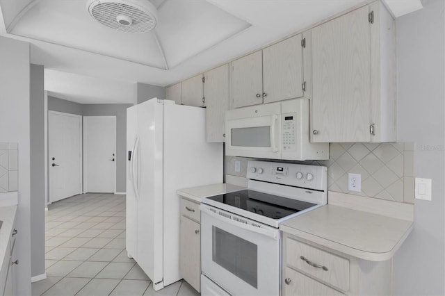 kitchen featuring light tile patterned floors, white appliances, and backsplash