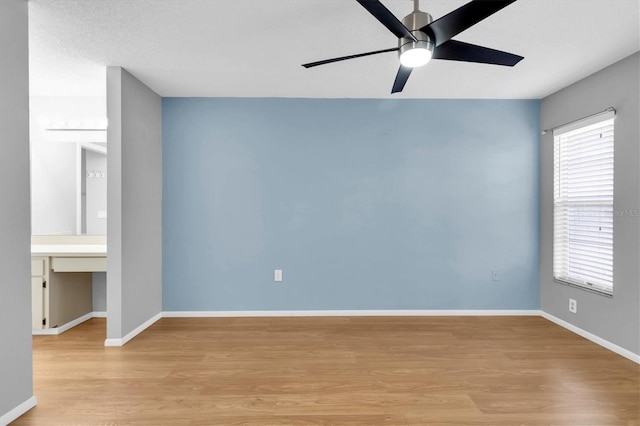 empty room featuring ceiling fan and light wood-type flooring