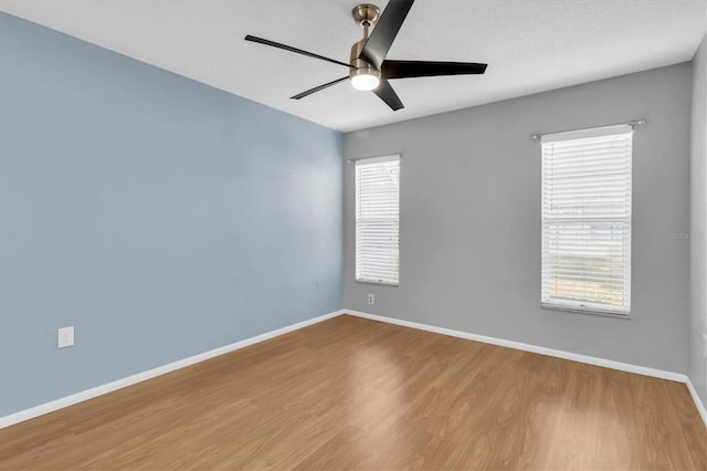 empty room with hardwood / wood-style flooring and ceiling fan