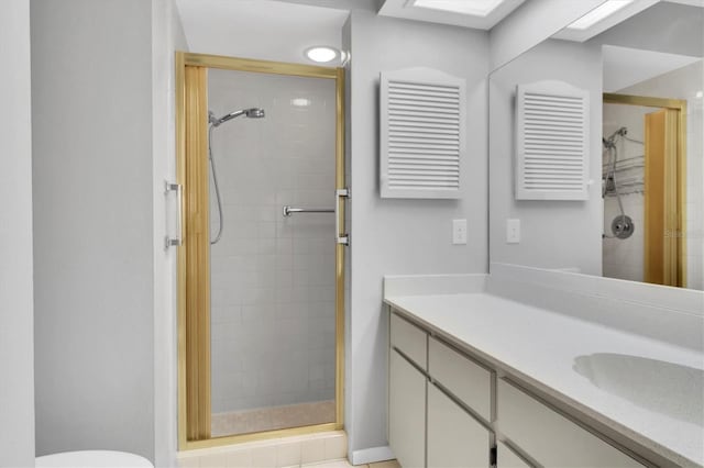 bathroom featuring vanity and a shower with shower door