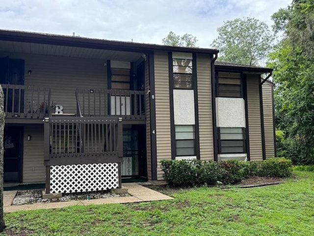 rear view of property with a yard