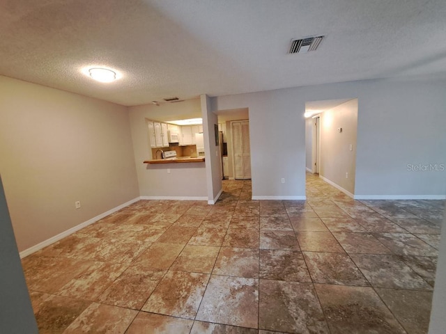 unfurnished living room featuring a textured ceiling