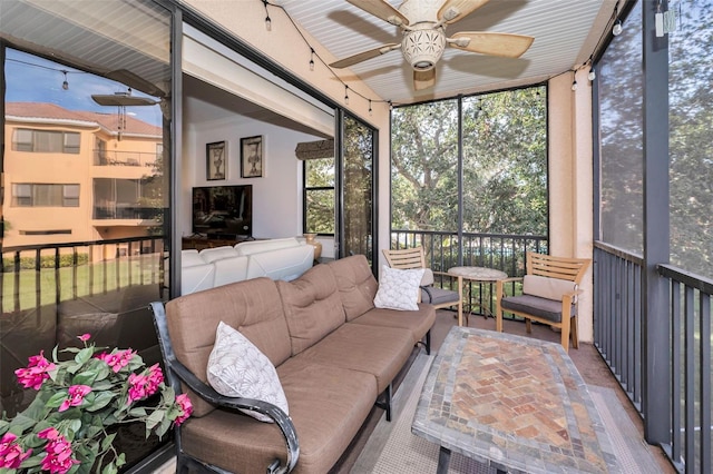 sunroom featuring ceiling fan