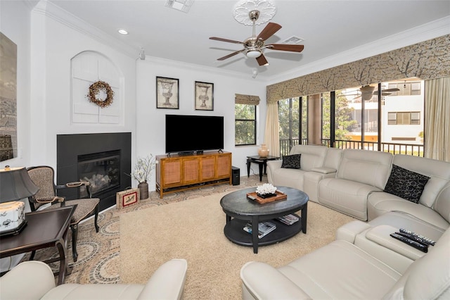 living room featuring crown molding and ceiling fan