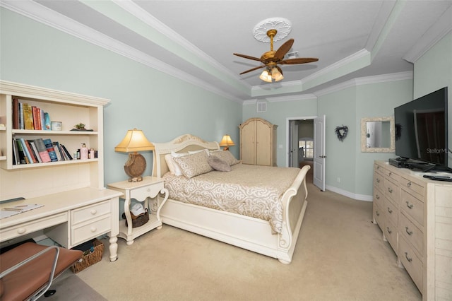 bedroom featuring light colored carpet, ceiling fan, crown molding, and a tray ceiling