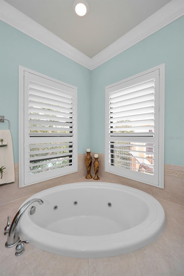 bathroom featuring a bathtub, a wealth of natural light, and ornamental molding