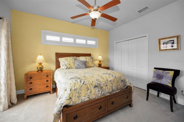 bedroom featuring light carpet, a closet, and ceiling fan