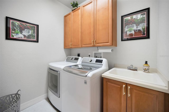 laundry area featuring sink, cabinets, and independent washer and dryer