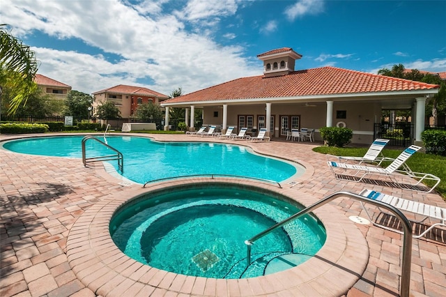 view of pool featuring ceiling fan, a community hot tub, and a patio