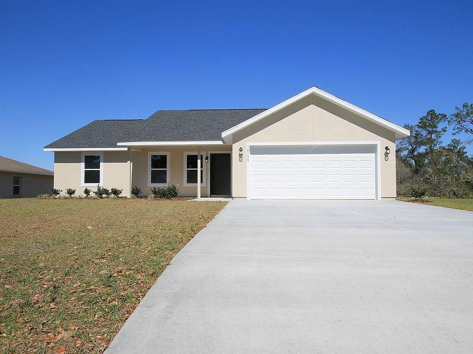 single story home featuring a garage and a front yard