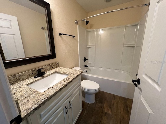 full bathroom featuring vanity, hardwood / wood-style flooring, toilet, and tub / shower combination