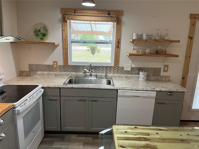 kitchen featuring backsplash, sink, white appliances, and ventilation hood