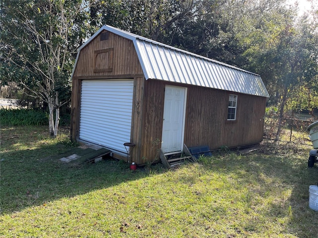 view of outdoor structure featuring a lawn