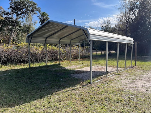 view of vehicle parking with a lawn and a carport