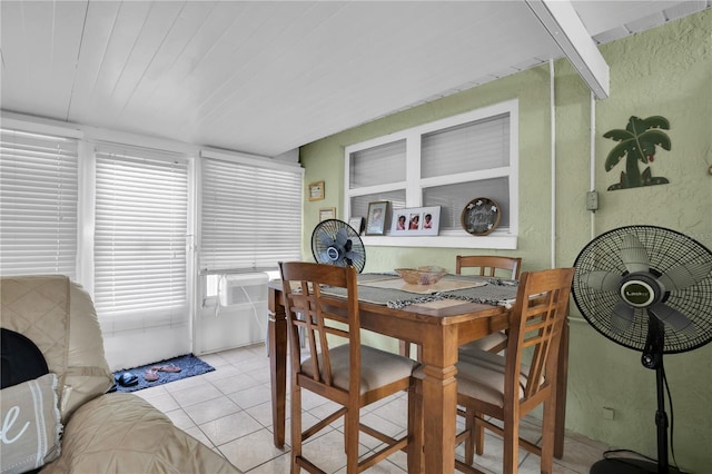 dining space with cooling unit and light tile patterned flooring