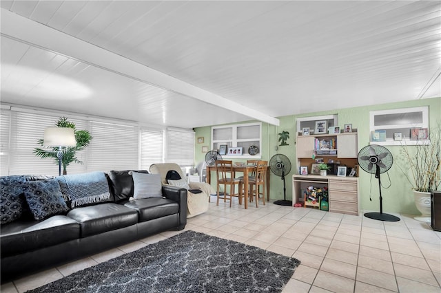 living room featuring beam ceiling and tile patterned flooring